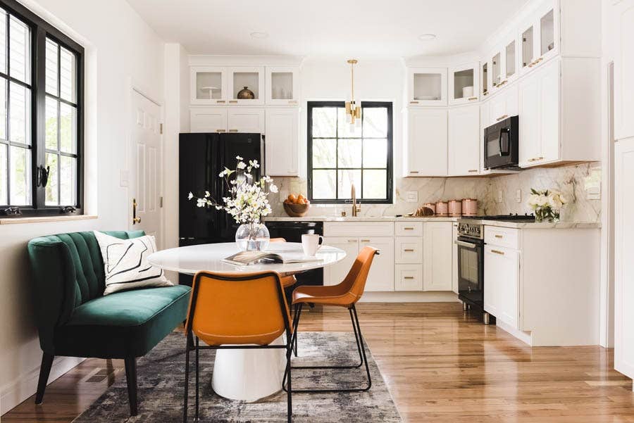 Shaker white kitchen cabinets with stacked glass cabinets and gold hardware