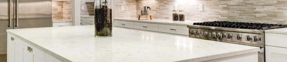 White shaker kitchen cabinets with white quartz countertops