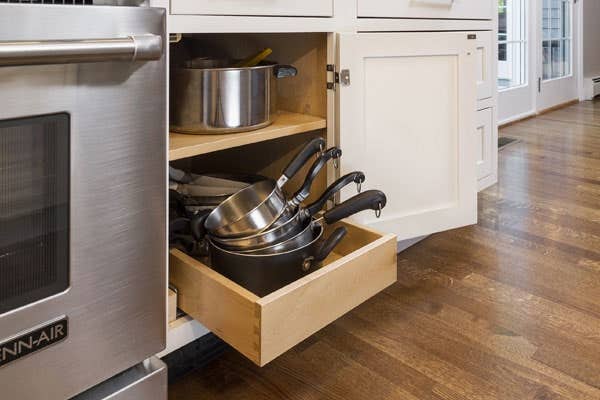 White shaker kitchen cabinets with one roll-out tray