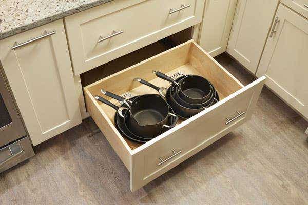 Pull-out deep drawer kitchen cabinets with pots and pans inside Pull-out deep drawer kitchen cabinets with pots and pans inside