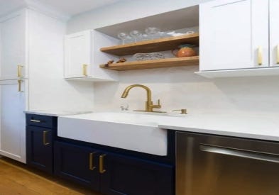 White and Blue shaker kitchen cabinets with floating shelves and gold hardware