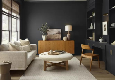 Soft black painted living room walls with cream, neutral, and light wood tone furniture