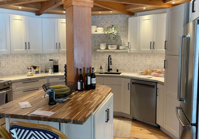 White shaker rustic farmhouse kitchen design in semi-circle shape and center island with wood beam on top and  wood beam ceiling with loft above