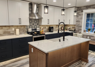 Farmhouse kitchen with white shaker wall cabinets, blue shaker base cabinets, and light wood furniture-style island