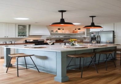 White and light gray shaker kitchen cabinets with shiplap wood range hood