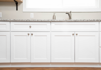Full overlay shaker cabinets in white with brushed nickel knobs