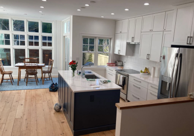 Stacked white shaker kitchen design with navy kitchen island