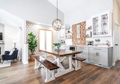 White and light gray shaker buffet cabinets and white subway tile backsplash and geometric wall paper