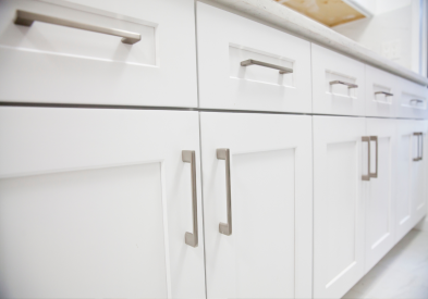 White shaker kitchen cabinets with large brushed nickel cabinet pulls