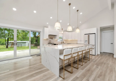 White shaker dream kitchen cabinets with quartz waterfall island countertop