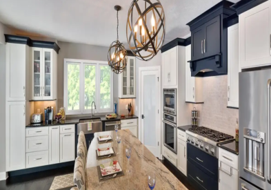 Shaker white kitchen cabinets with a black wood range hood and black accent molding.