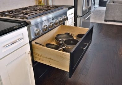 Smart storage solutions by CliqStudios keeps your kitchen organized with features such as this base cabinet with extra deep drawers to store bulky items like pots and pans, shown here in Dayton shaker cabinet style in painted Carbon finish and paired with