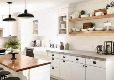 View this white washed kitchen featuring concrete countertops and open shelves. Our CliqStudios Shaker style cabinets complement the modern design.