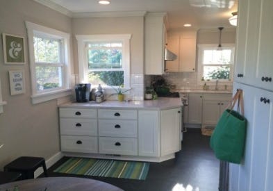 Photo gallery of remodeled kitchen features CliqStudios Shaker Painted White cabinets and built-in window seat