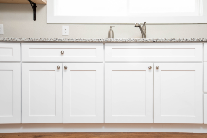 Full overlay shaker cabinets in white with brushed nickel knobs