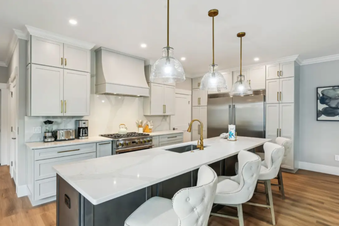 Light gray and dark wood kitchen design with a large kitchen island