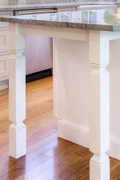 Shaker in white kitchen island legs, square posts.