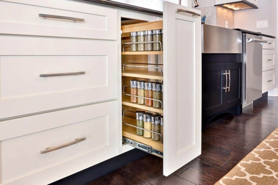 Smart storage solutions by CliqStudios keeps your kitchen organized with features such as this base cabinet with pull-out spice rack, shown here in Dayton shaker cabinet style in painted White finish.