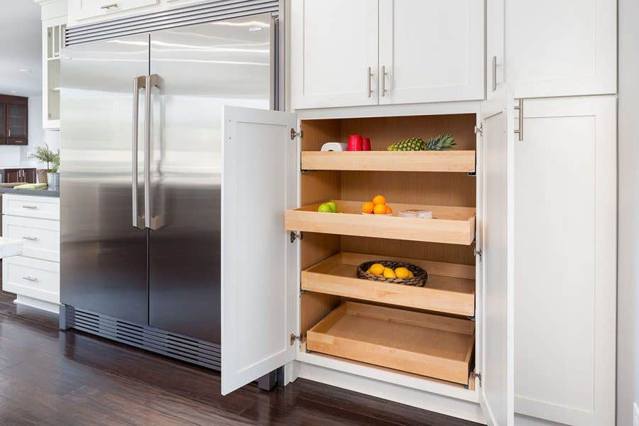 modern kitchen cabinets include pantry with roll-out shelves and custom built-in refrigerator surround.