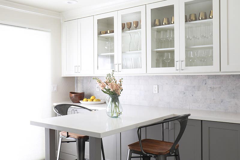 A gray and white two-toned kitchen using CliqStudios Shaker cabinets in White and Medium Gray.