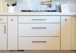 Image of a kitchen using CliqStudios Slab cabinets painted white.