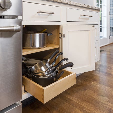 Kitchen using CliqStudios Shaker Inset painted White cabinets with roll-out drawers.