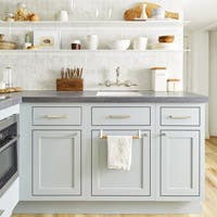 small kitchen with inset cabinets in blue color Blue-Gray with white backsplash and floating shelves above