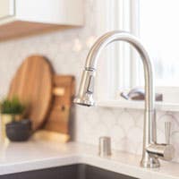 kitchen sink with white backsplash