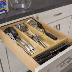 Utensil divider inside a shaker cabinet drawer