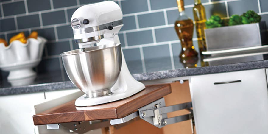 White electric mixer on a base mixer shelf.