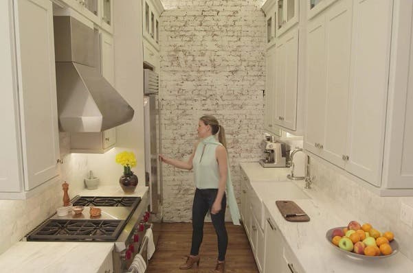 woman in nyc apartment with kitchens with tall cabinets