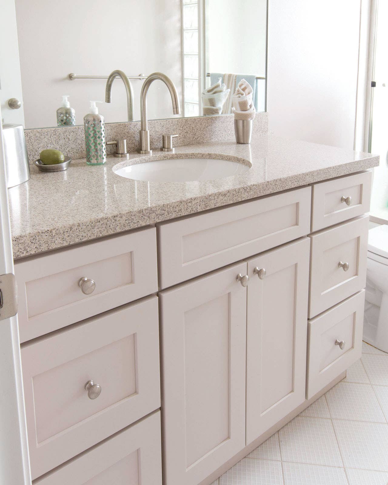 CliqStudios bath cabinets shown in Shaker White door style and finish