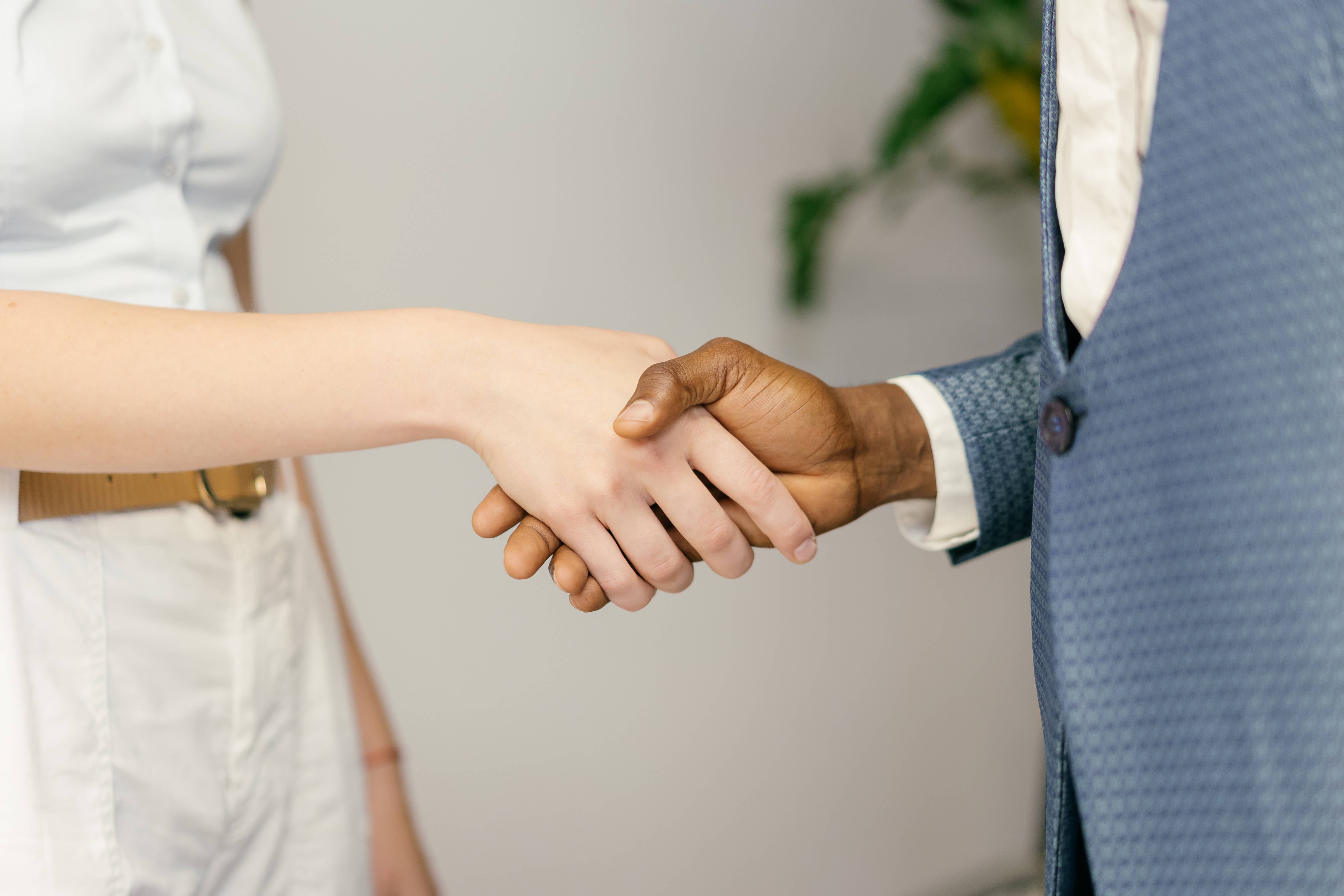 Two parties shaking hands in agreement Two parties shaking hands in agreement