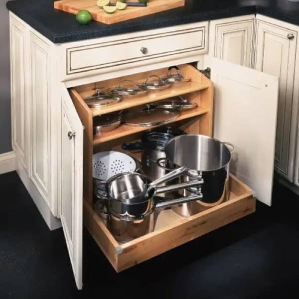 Base pots and pans pull-out organizer Base pots and pans pull-out organizer in cream raised panel cabinets