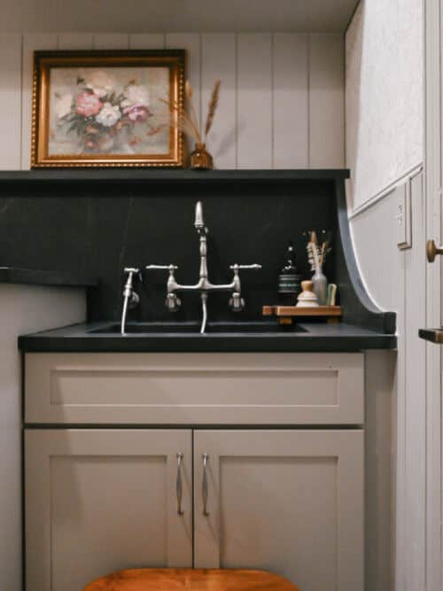 Berkeley Chai Latte laundry room cabinets Laundry room wall with beige laundry room sink cabinet, brushed nickel hardware and black quartz countertops