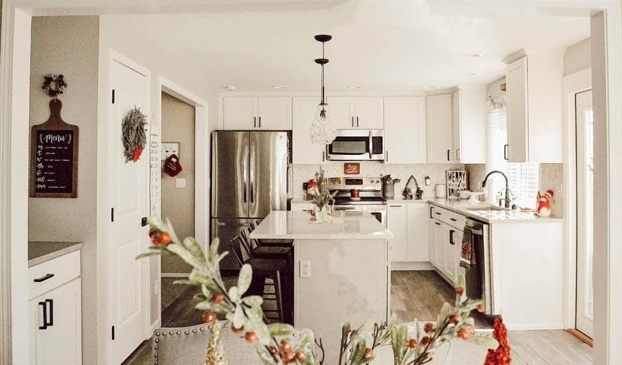 White shaker kitchen cabinets with island and oil rubbed bronze hardware