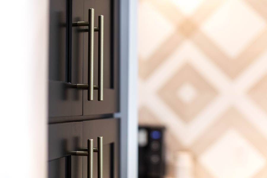 Black shaker pantry cabinet with modern nickel door pulls Black shaker pantry cabinet with modern nickel door pulls