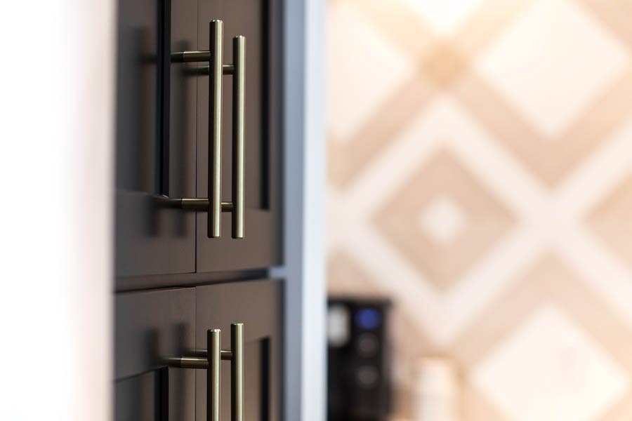 Black shaker pantry cabinet with modern nickel door pulls