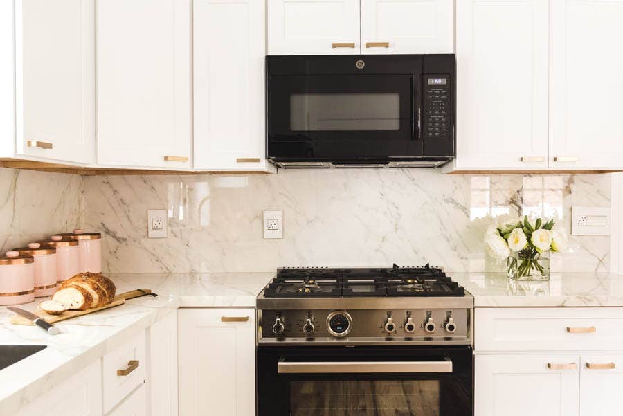Over-the-Range Microwave and Vent Fan in a White Shaker Kitchen Cabinet. Over-the-Range Microwave and Vent Fan in a White Shaker Kitchen Cabinet.