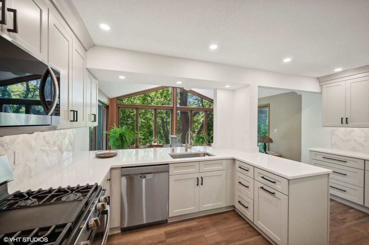 Light gray shaker kitchen cabinets with peninsula design 