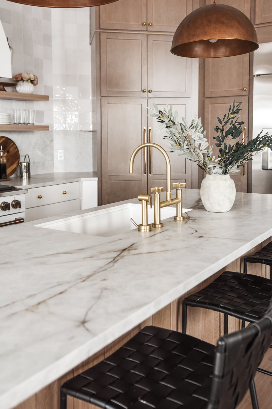 White and light-brown stained kitchen cabinets and island