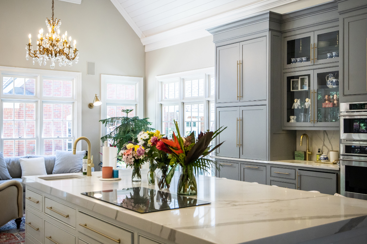 Custom blue inset kitchen cabinets and white quartz countertops with a gold chandelier Custom blue inset kitchen cabinets and white quartz countertops with a gold chandelier