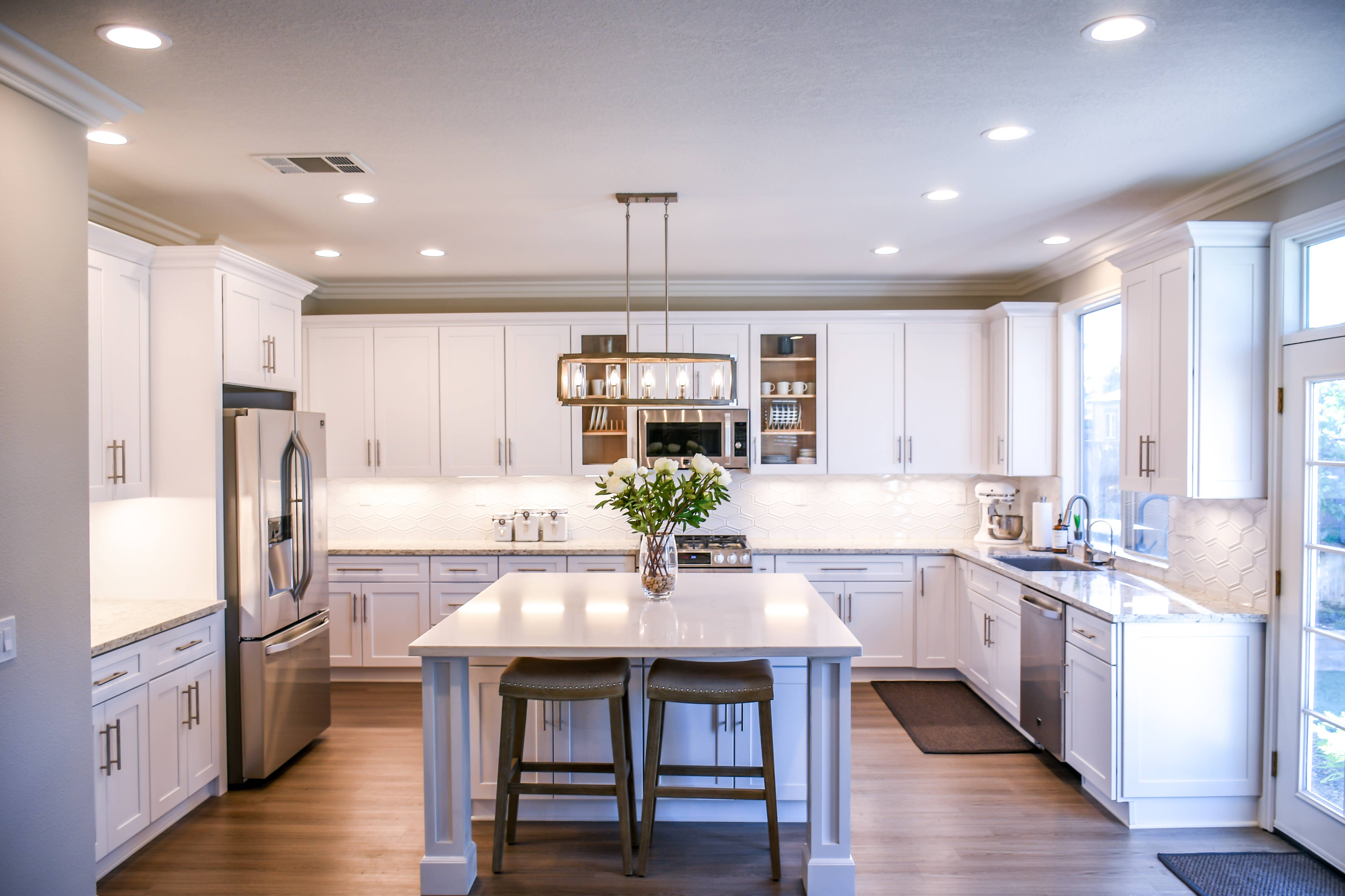 White shaker kitchen with can lighting, pendant lighting, and under-cabinet lighting. White shaker kitchen with can lighting, pendant lighting, and under-cabinet lighting.