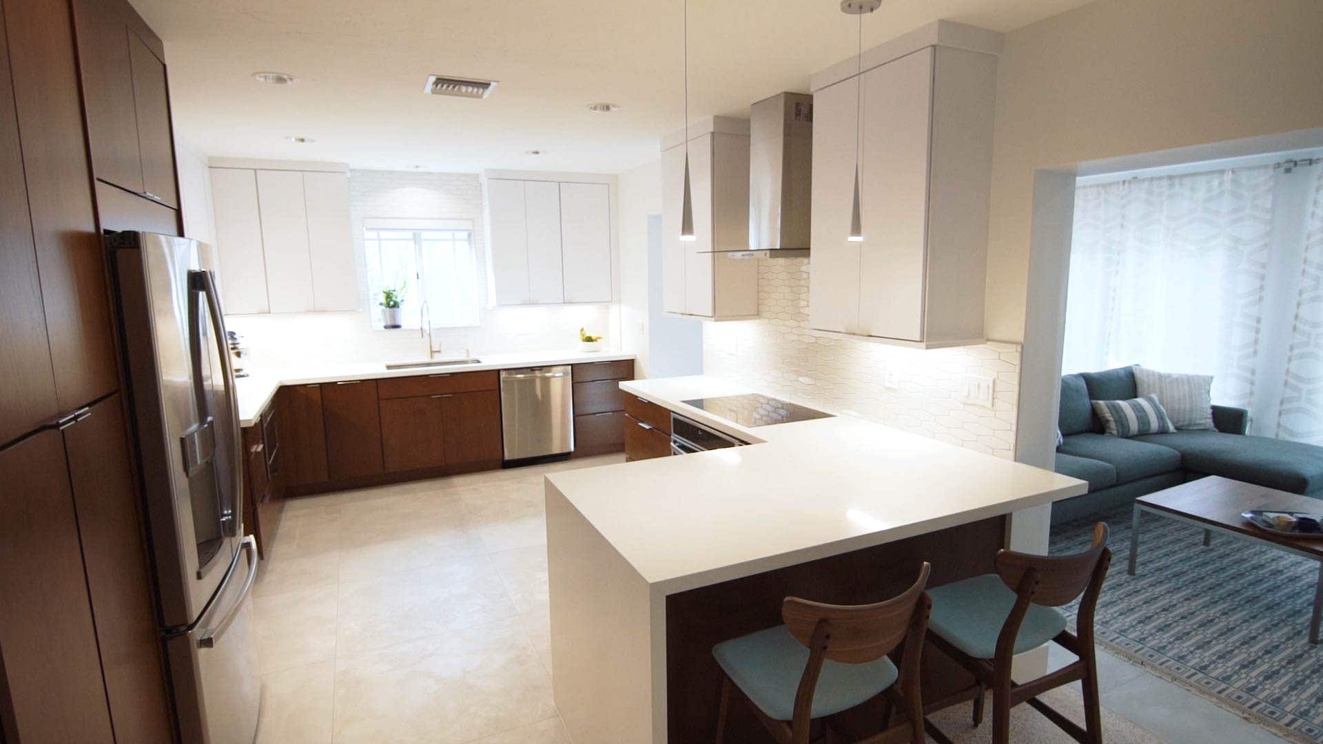 A mid-century design with two-tone cabinetry in cherry stain and white A mid-century design with two-tone cabinetry in cherry stain and white