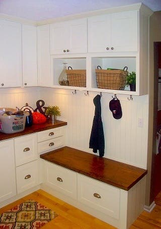 laundry room locker zone created with white shaker cabinets and beadboard wall