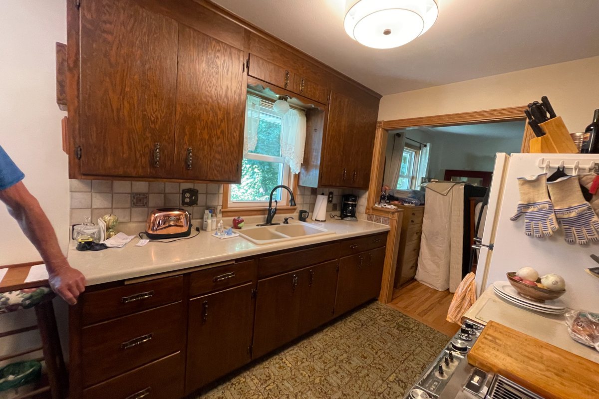 Dark and outdated oak cabinets with old aged vinyl flooring and laminate countertops Dark and outdated oak cabinets with old aged vinyl flooring and laminate countertops