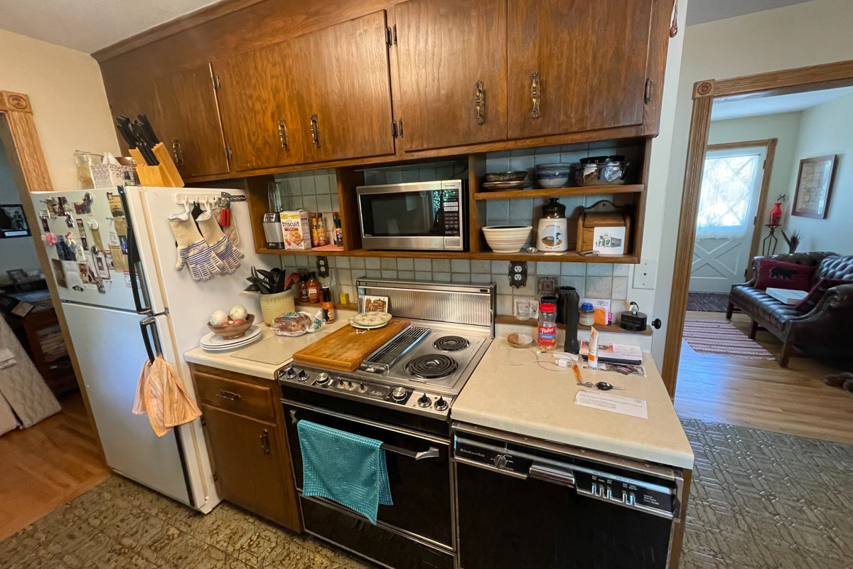Dark and outdated oak cabinets with old aged vinyl flooring and laminate countertops Dark and outdated oak cabinets with old aged vinyl flooring and laminate countertops