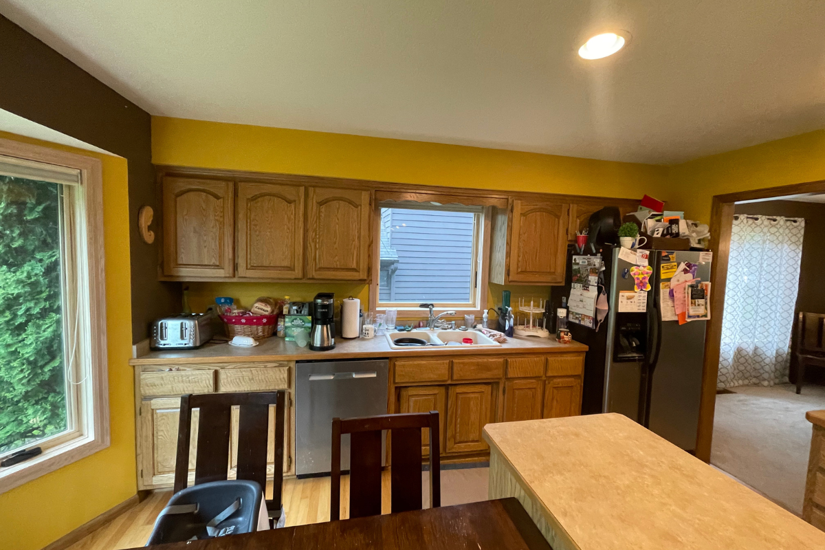 Client before photo of golden oak arched raised panel doors, a narrow island, and soffits Client before photo of golden oak arched raised panel doors, a narrow island, and soffits