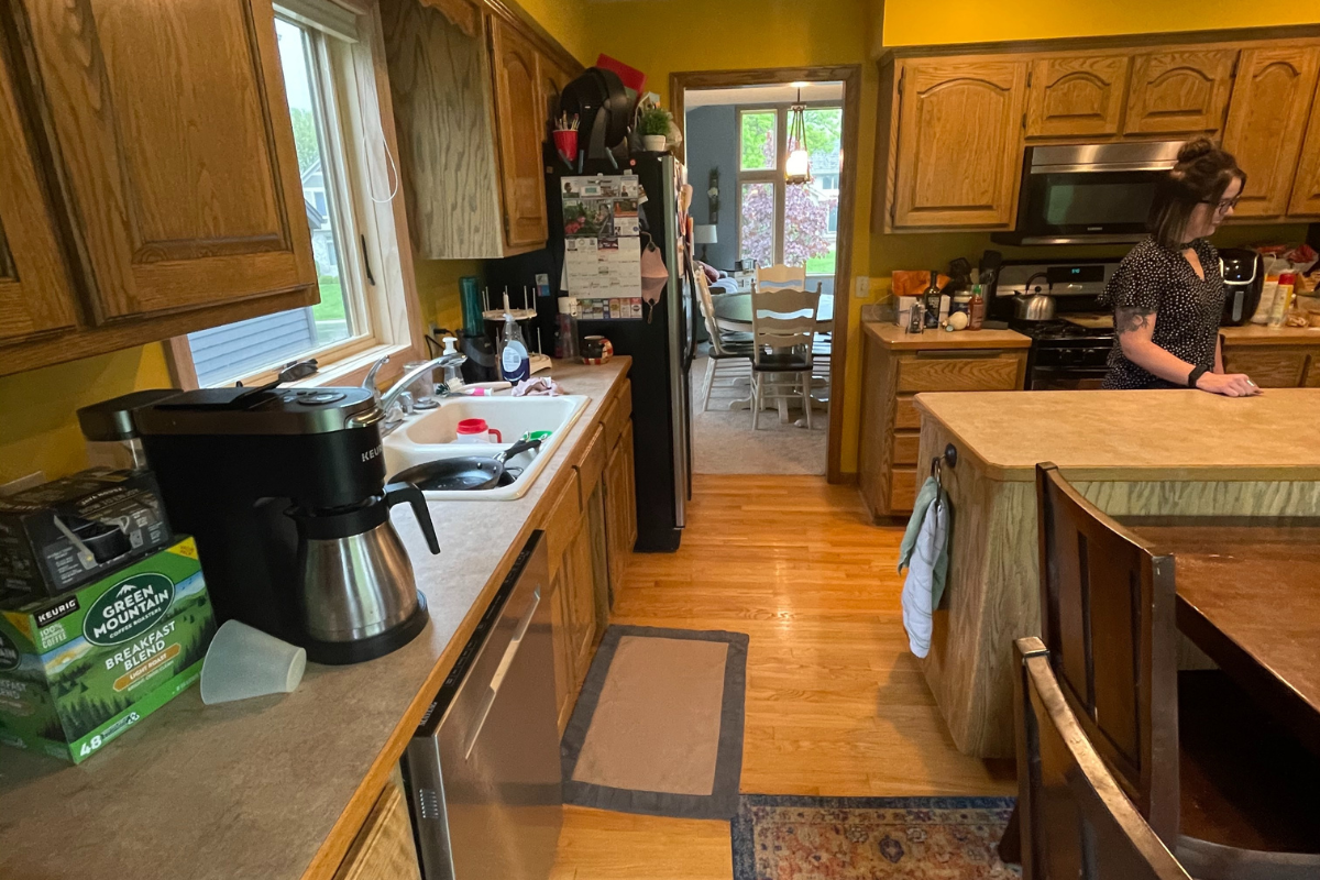 Client before photo of golden oak arched raised panel doors, a narrow island, and soffits Client before photo of golden oak arched raised panel doors, a narrow island, and soffits