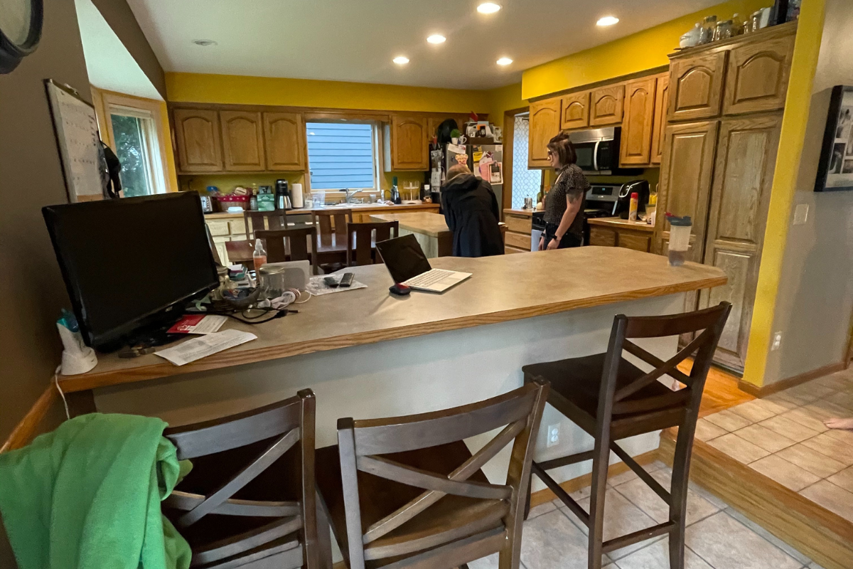 Client before photo of golden oak arched raised panel doors, a narrow island, and soffits Client before photo of golden oak arched raised panel doors, a narrow island, and soffits